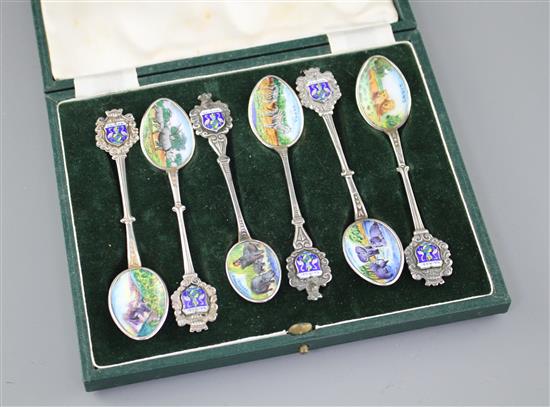 Six white metal and enamel teaspoons, decorated with Nairobi safari scenes with animals, unmarked, 11.2cm, gross 2.9oz.